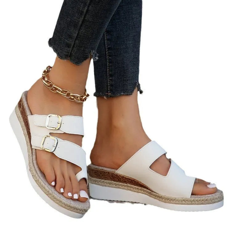 White patent leather wedge sandals with woven finger-fit straps and a peep toe design on a rubber sole.