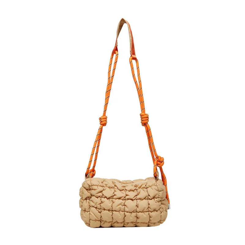 Women's lightweight nylon messenger bag in pillow shape with a crossbody strap, shown in rose red with a rhombus pattern.
