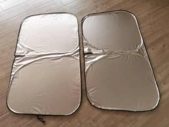 Titanium silver aluminium foil car sunshade folded, showing its reflective surface.