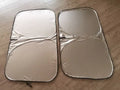 Titanium silver aluminium foil car sunshade folded, showing its reflective surface.