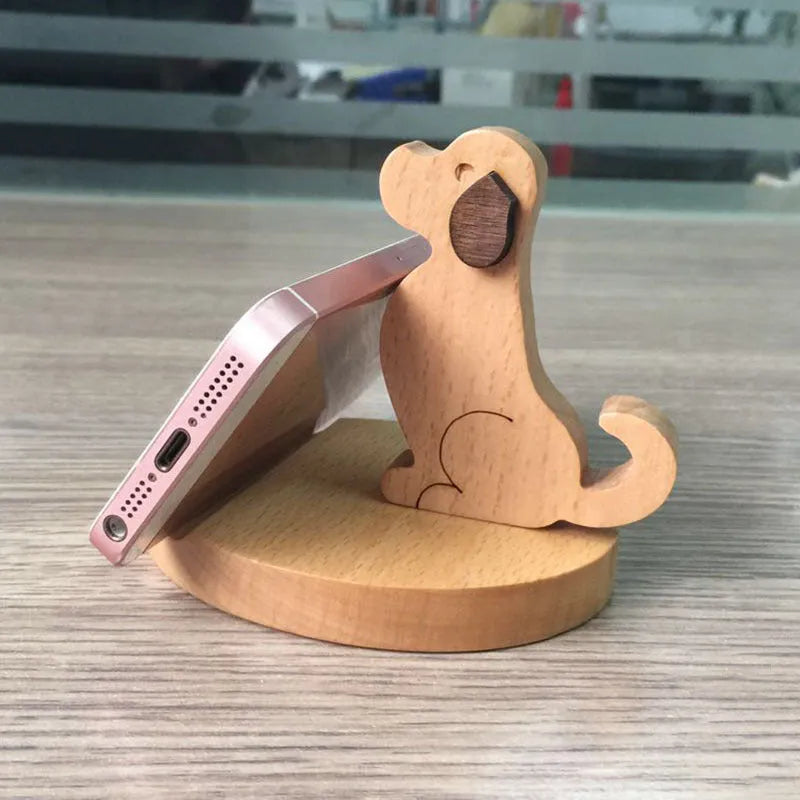 Beech wood and resin lazy bracket mobile phone holder with decorative animal design on a desk.