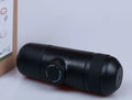 Black portable manual coffee machine measuring 6cm by 17.5cm with stainless steel components