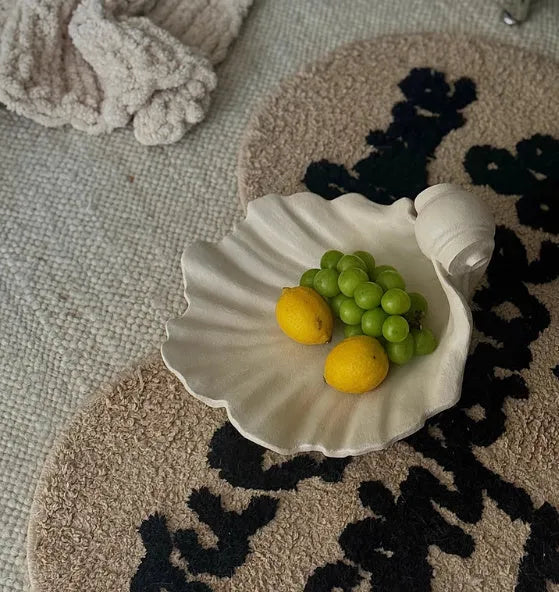 White resin fruit plate decoration with simulation shell design on table