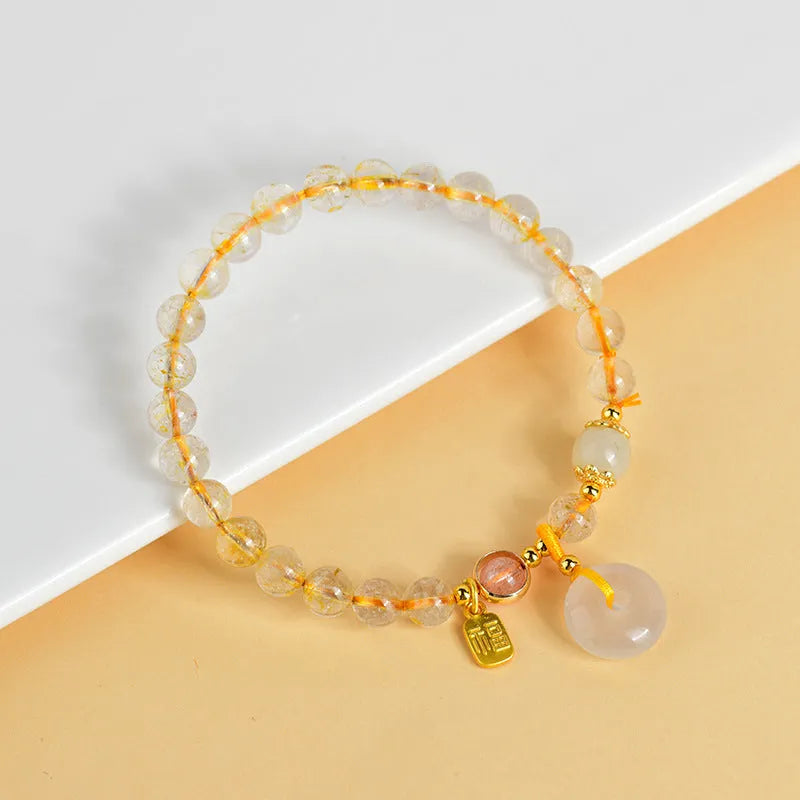 Gold rutilated quartz crystal bracelet with safety buckle and geometric pendant