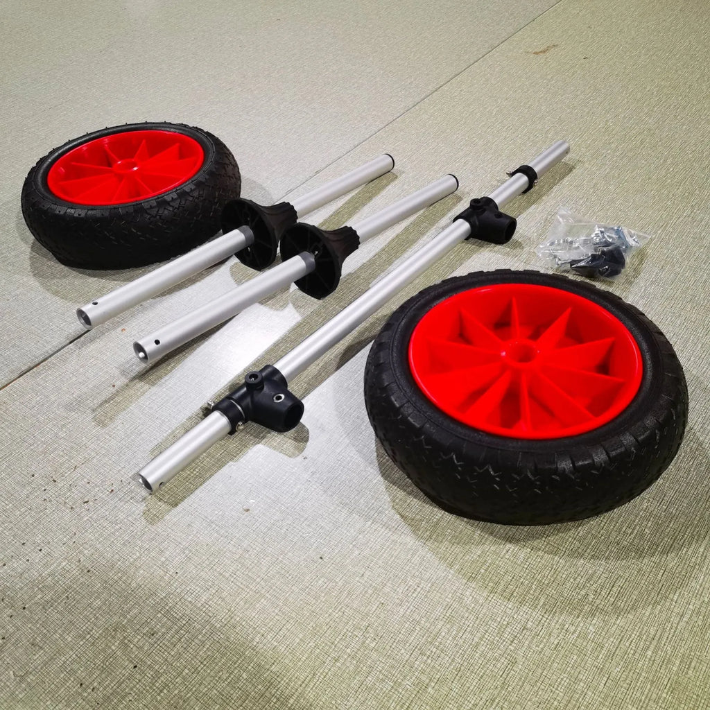Foldable kayak beach trailer with aluminium frame and rubber wheels on sand.