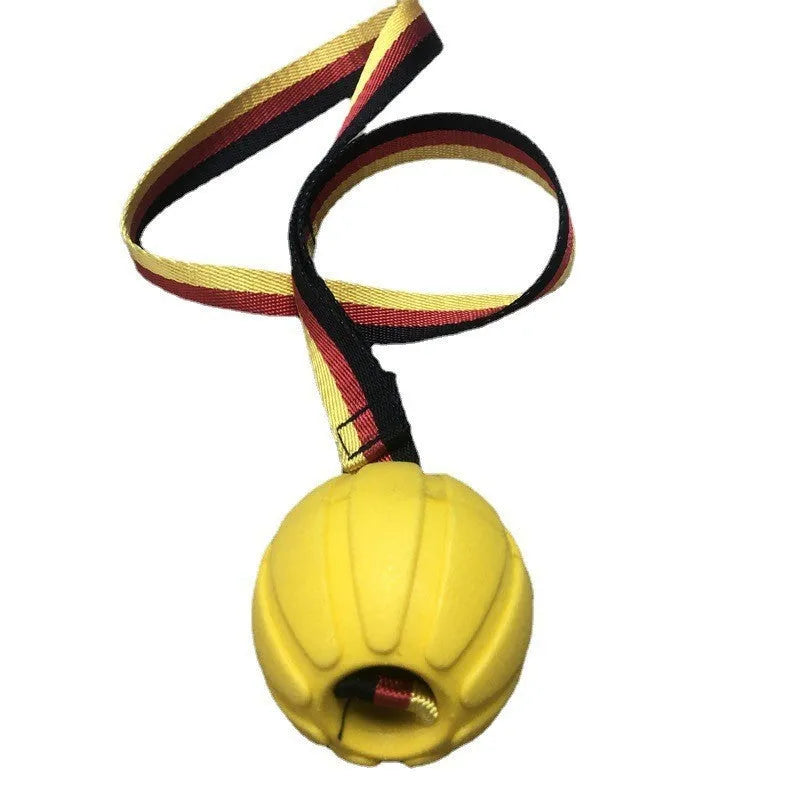 Yellow and camouflage coloured EVA floating dog balls with strings in three different sizes on a blue background.