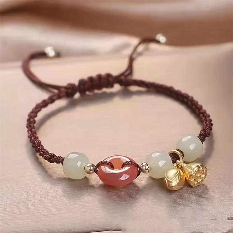 Hetian jade peace buckle bracelet on a brown strap, showing constellation detail.
