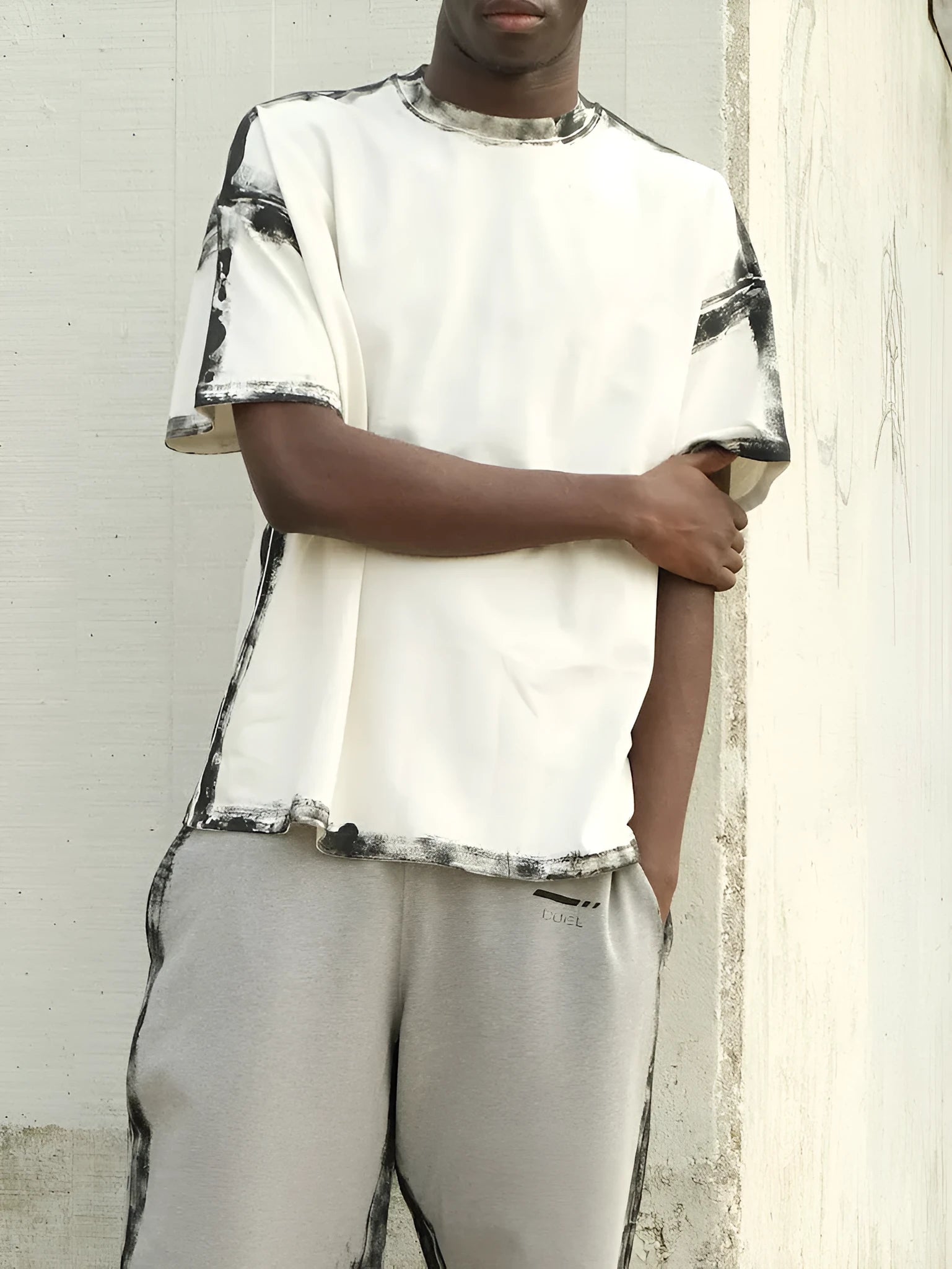 White short sleeve casual top with draped design and printed detail on polyester fabric