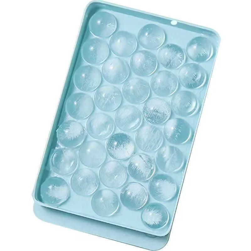 Blue silicone ice cube tray with lid showing 33 round cavities.