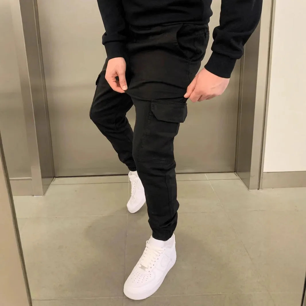 Men's light blue loose-fit casual polyester trousers with patch pockets and an elastic waistband.