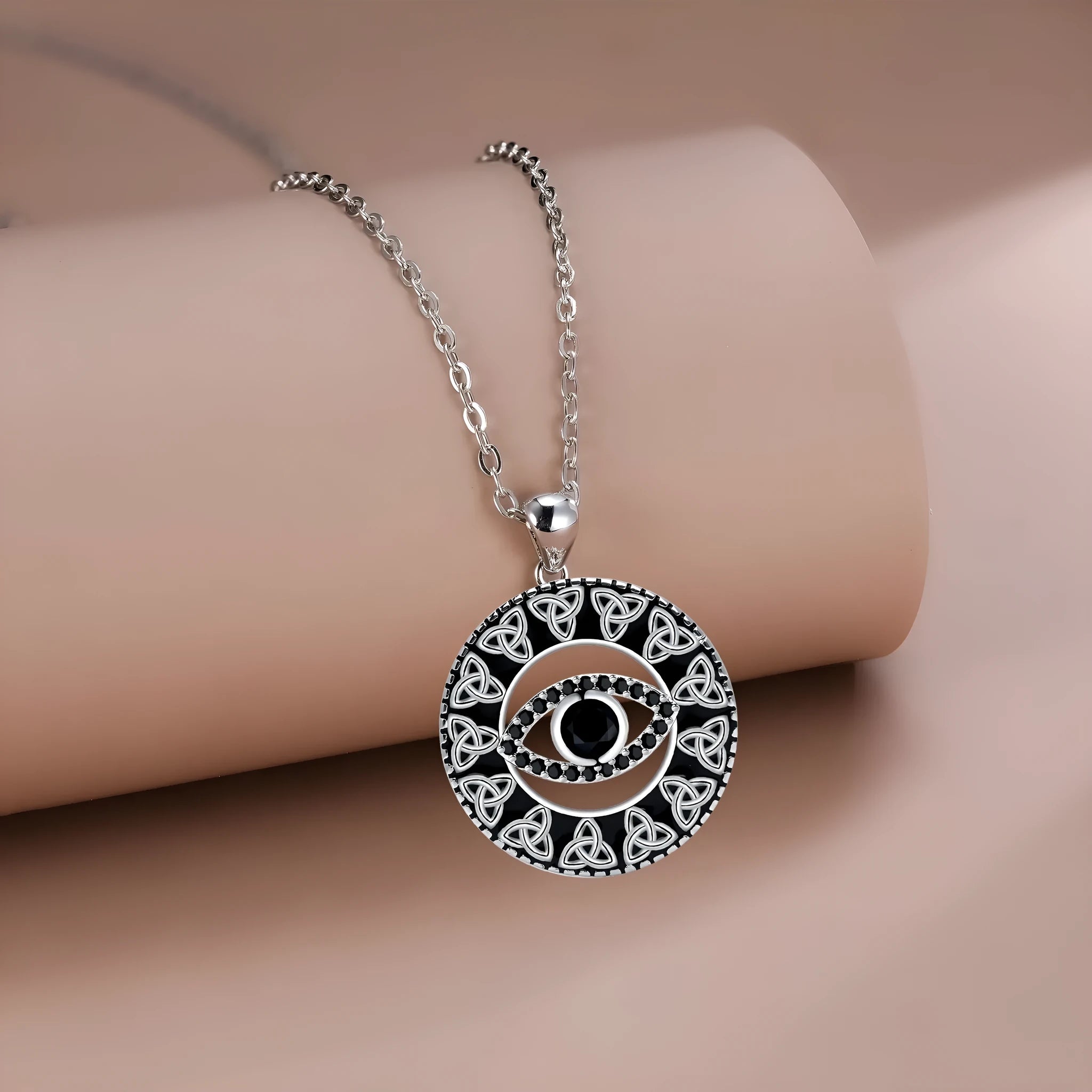 Close-up of a women's copper Devil's Eye pendant necklace on a cross chain, with a light luxury electroplated finish.