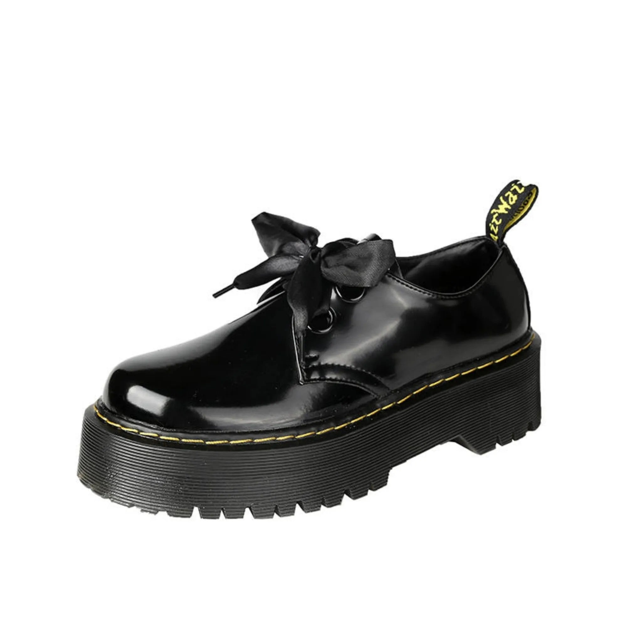 Women's black and white lace-up shoes with thick soles, ribbon details, and cross straps.