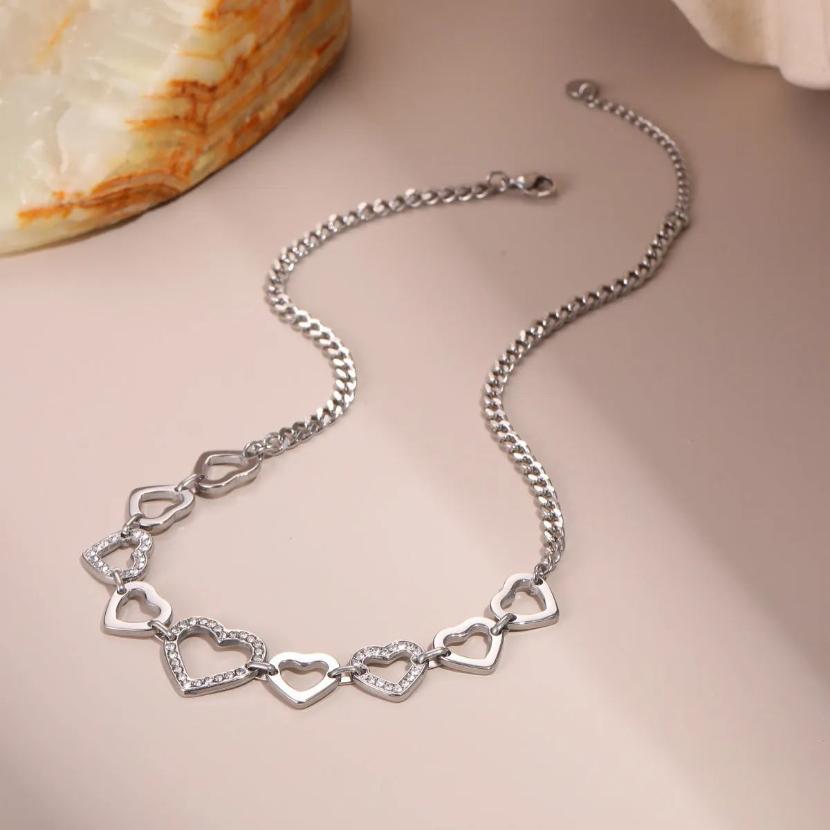 Geometric heart-shaped stainless steel necklace with 18K gold electroplated finish on clavicle chain