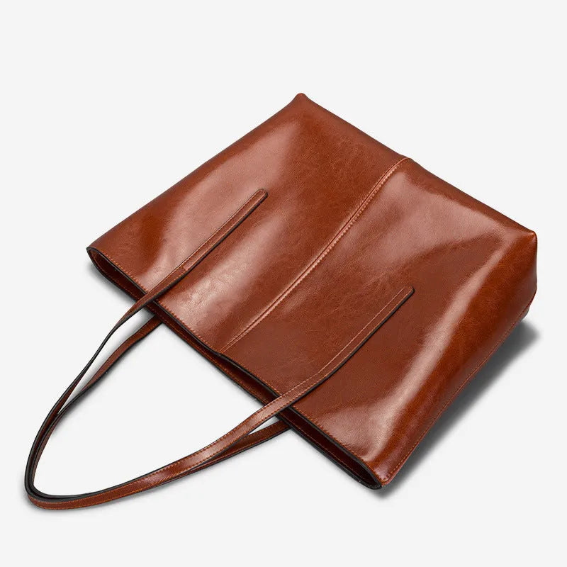 Women's retro style cowhide shoulder bag in horizontal square shape with multiple internal compartments