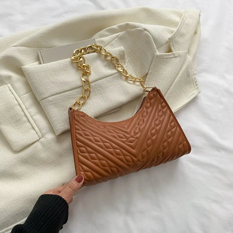 Brown pleated PU baguette shoulder bag showing its vertical square shape and chain strap.