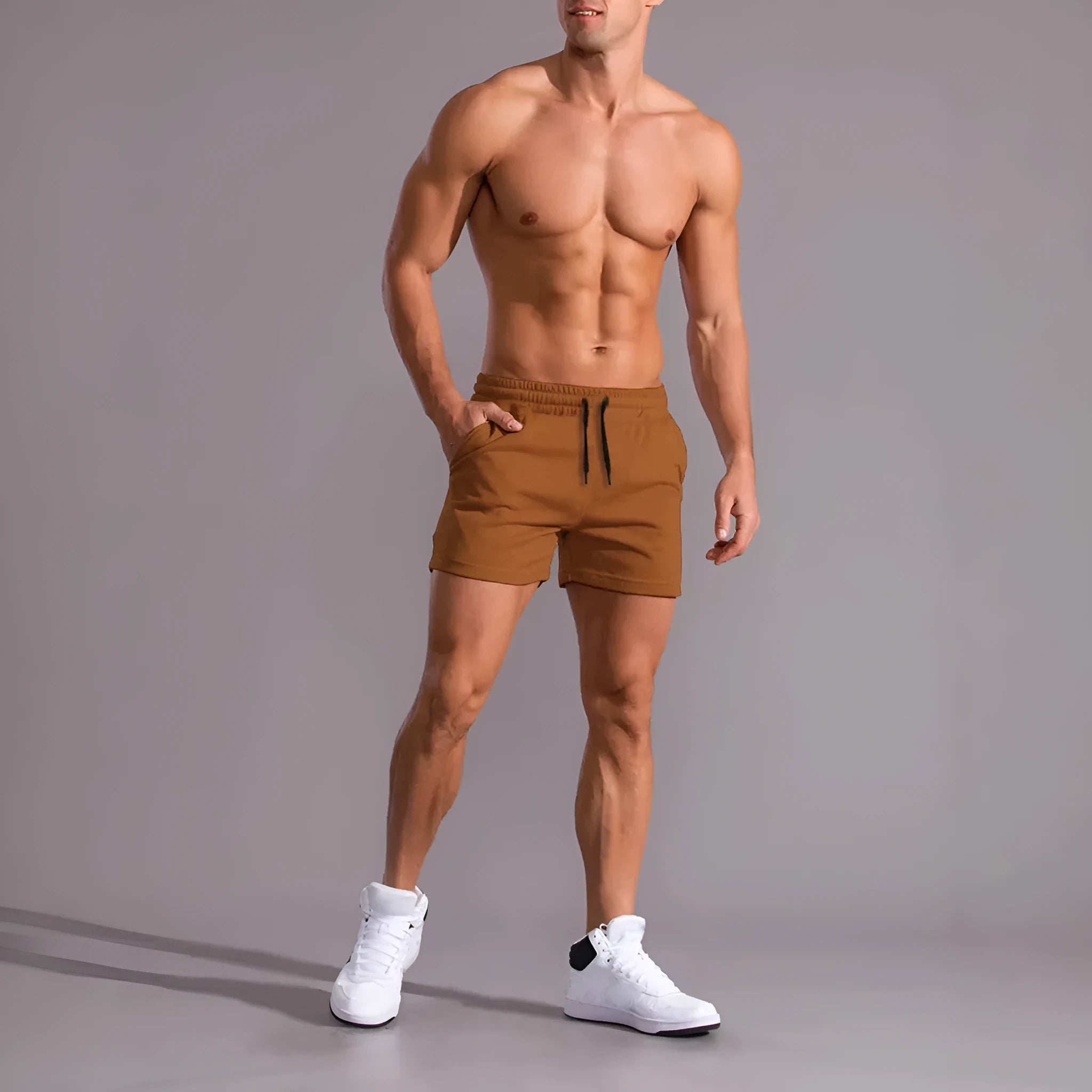 A pack of three men's solid colour drawstring shorts in black, khaki, and light brown, laid flat.