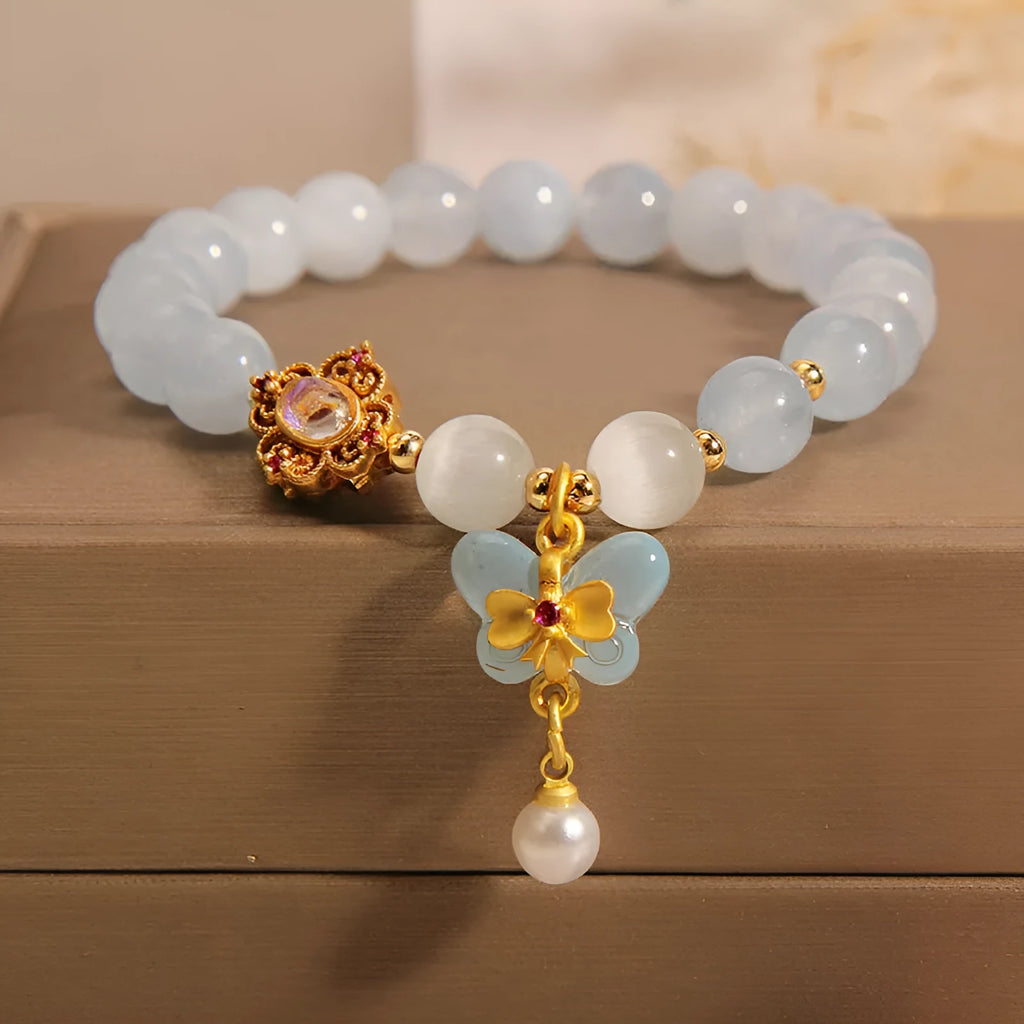 Aquamarine butterfly pendant crystal bracelet for women with rhinestone details on silver chain.