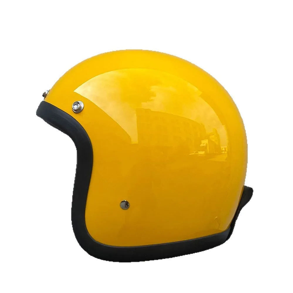 Retro-style open face motorcycle helmet in fibreglass, shown in a selection of colours including cement grey and matte black.
