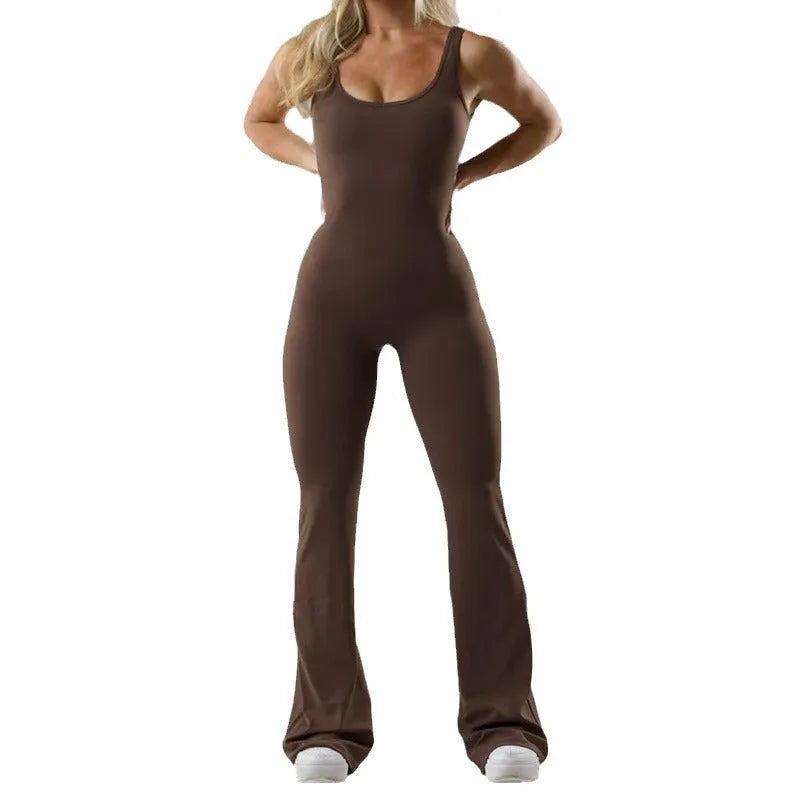 Black seamless women's yoga bodysuit jumpsuit with built-in chest pad, shown on model.