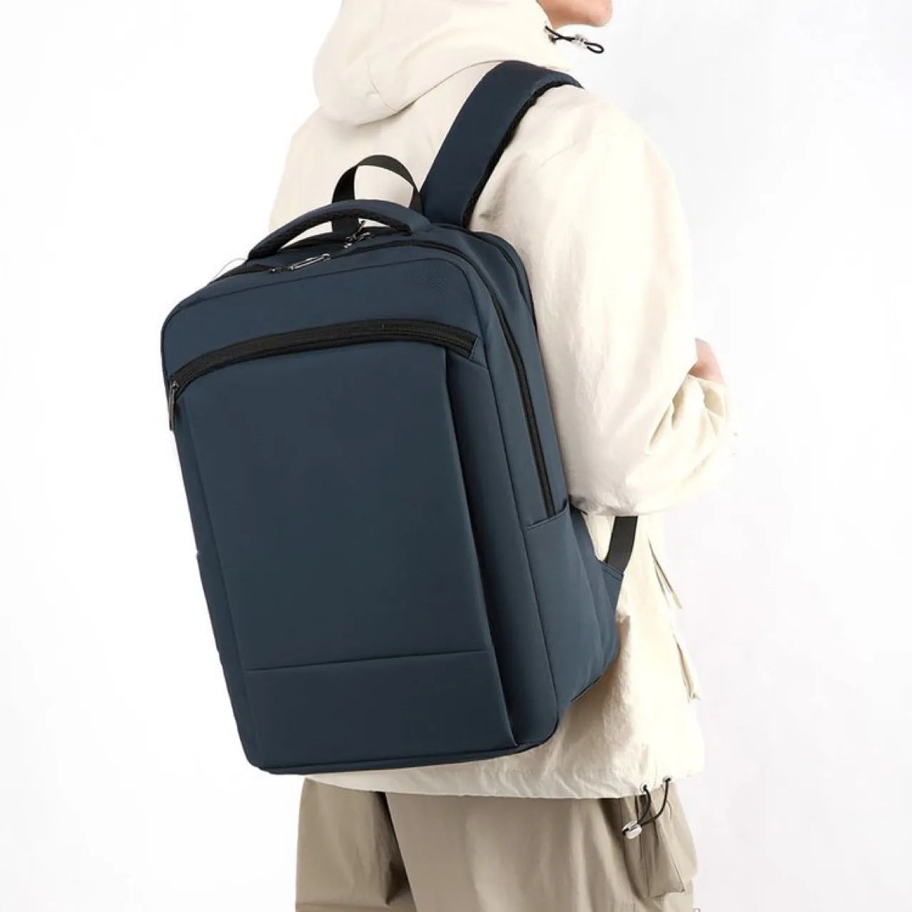 Gray casual business commute computer backpack with large capacity and curved shoulder straps on plain background