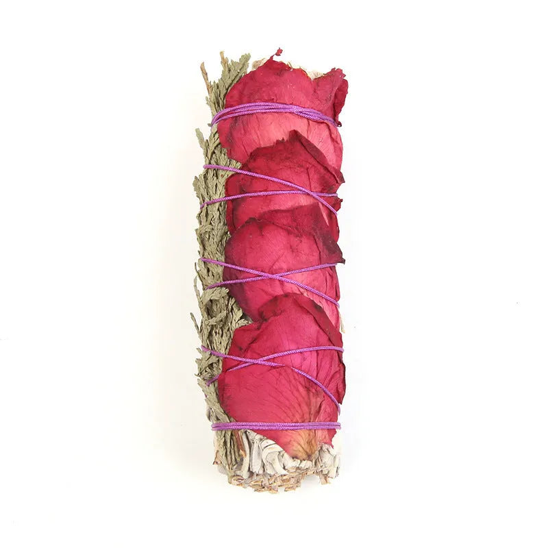 White sage and red rose petal colourful aromatherapy incense bundle on a wooden table