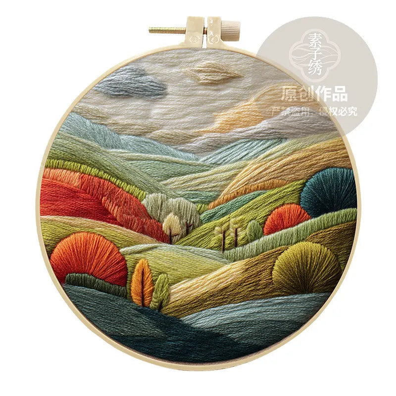 Embroidery DIY kit with cotton fabric, bamboo frame, scissors, and printed landscape pattern
