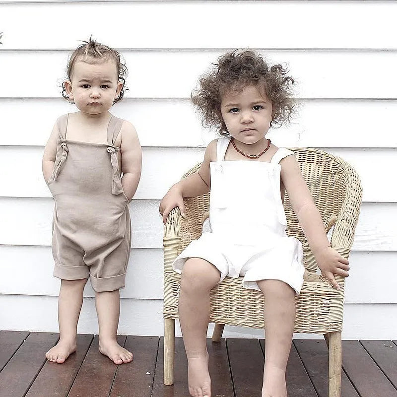 Children's khaki cotton overalls shorts with bow detail and straps, front view