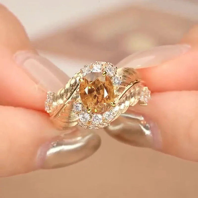 Women's gold copper ring with embossed feather pattern and yellow zircon stones