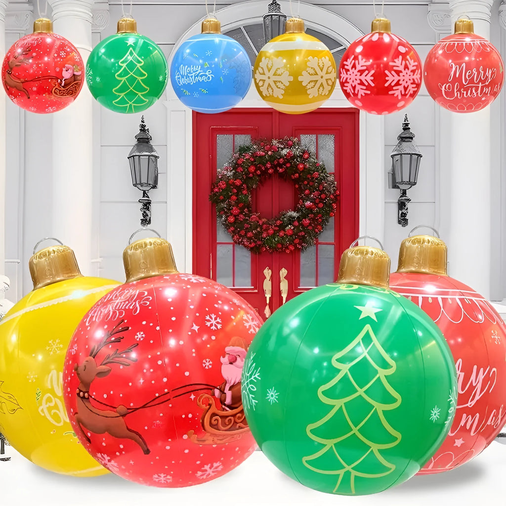 Large red and white inflatable Christmas ball with snowflake design and LED lights in a garden