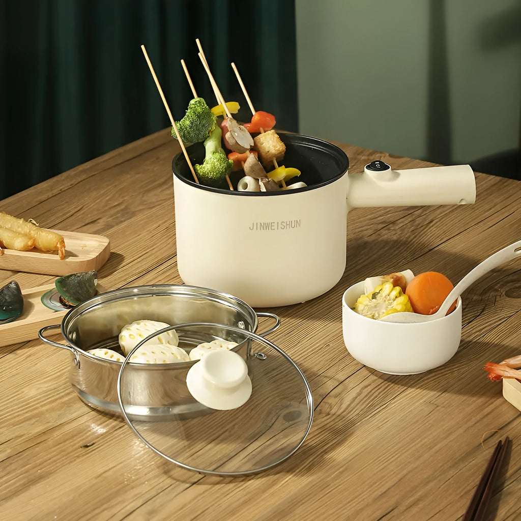 Compact white electric multi-function hot pot with non-stick interior on a kitchen countertop