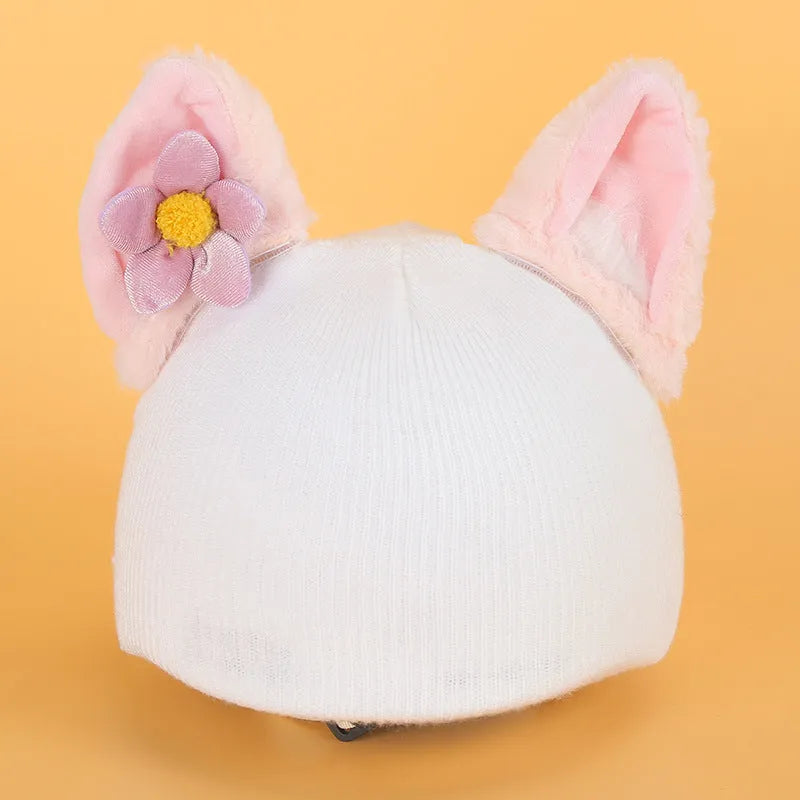 Plush cartoon-themed cover set on a medium motorcycle helmet with soft ear decorations.