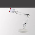 Black universal phone stand with long rotating metal arms and a heavy round base on a wooden desk.