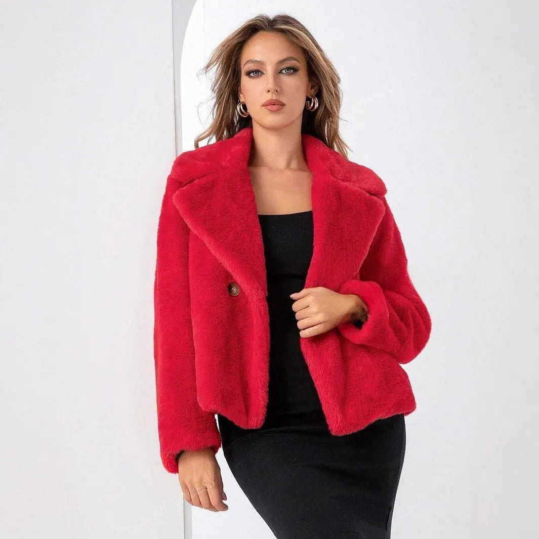 Women's short loose-fit faux fur coat in rose red on a hanger, showing regular sleeves and plush texture.